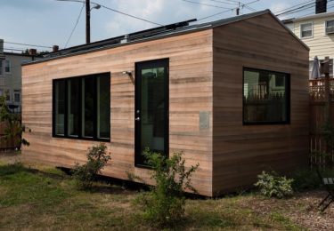 Minim House is clad in untreated, shiplapped cypress, with mitred corners, and will age to a light grey. The cypreseen in cypress is a natural preservative. Frank Lloyd Wright’s Pope-Leighey house in VA used a similar technique in the 1940′s and is still intact.