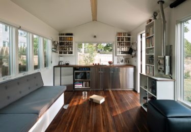 A 10 foot wide galley affords room for 2 cooks in the kitchen. It’s designed to accommodate a 7.1 cubic foot refrigerator under the counter, or has adequate room for a fuller size fridge to either side of the kitchen window. Kitchen wall space can accomodate mason jar racks with 50+ quart jars.